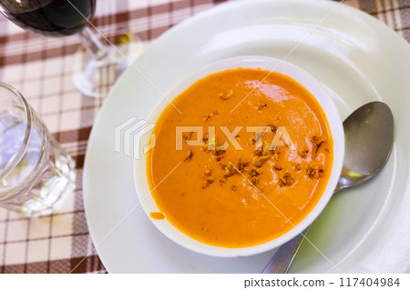Traditional spanish salmorejo. Tomato soup served with egg and iberico jam 117404984
