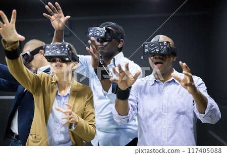 Multiethnic friends using virtual reality glasses Multiethnic friends using virtual reality glasses 117405088