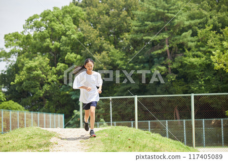 Elementary school girls having fun playing in the park during summer vacation 117405089