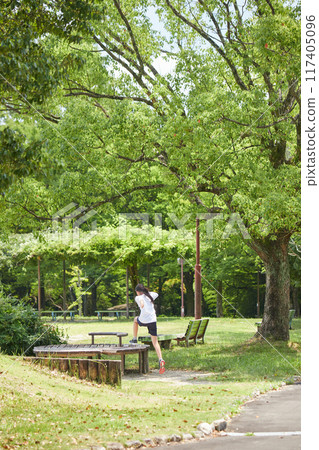 Elementary school girls having fun playing in the park during summer vacation Elementary school girls having fun playing in the park during summer vacation 117405096