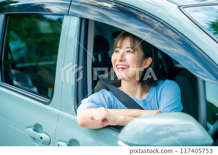A woman driving a car A woman going for a drive 117405753
