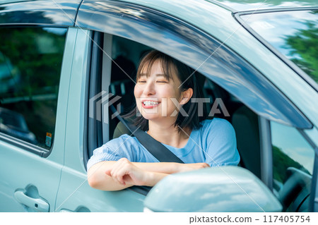 A woman driving a car A woman going for a drive 117405754