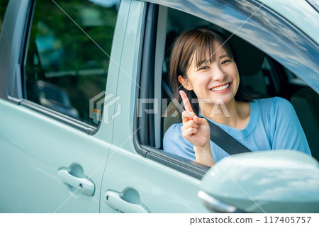 A woman driving a car A woman going for a drive 117405757