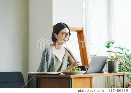 Woman teleworking at home 117406219