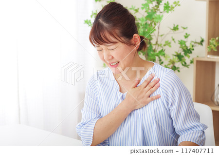 Middle woman suffering from chest pain 117407711