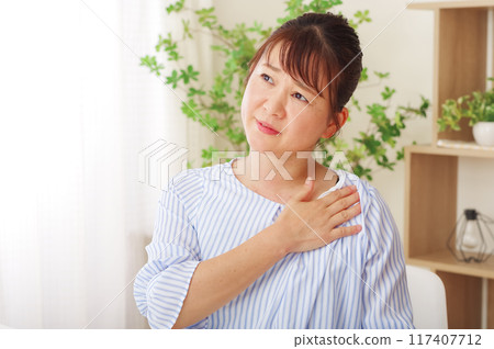 Middle woman suffering from chest pain 117407712