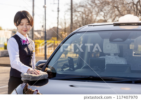 Female driver polishing a taxi Female driver polishing a taxi 117407970