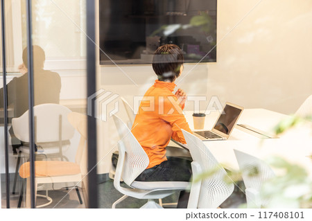 young woman having a video conference 117408101