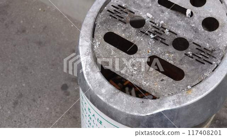 ashtray and cigarette butts 117408201