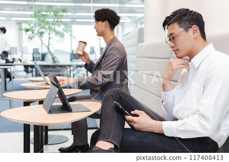 Businessman working in designer's office 117408413