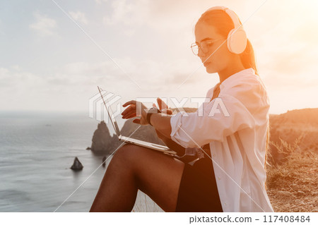 Woman sea laptop. Business woman, freelancer with laptop working over blue sea beach. Happy smiling girl relieves stress from work. Freelance, remote work on vacation, digital nomad, travel concept Woman sea laptop. Business woman, freelancer with laptop working over blue sea beach. Happy smiling girl relieves stress from work. Freelance, remote work on vacation, digital nomad, travel concept 117408484