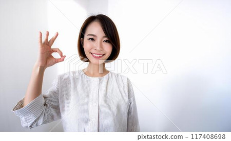 A young business woman giving an OK A young business woman giving an OK 117408698