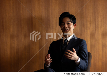 Businessman being interviewed with enthusiasm Businessman being interviewed with enthusiasm 117409653