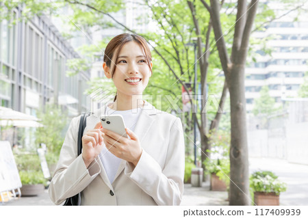 Young woman searching on her smartphone Young woman searching on her smartphone 117409939