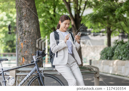 Young woman commuting by bicycle Young woman commuting by bicycle 117410354