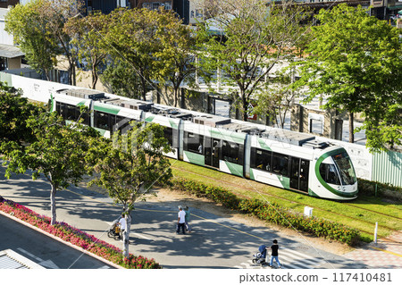 The circular light rail train drives past Pier-2 Art Center in Kaohsiung, Taiwan. 117410481