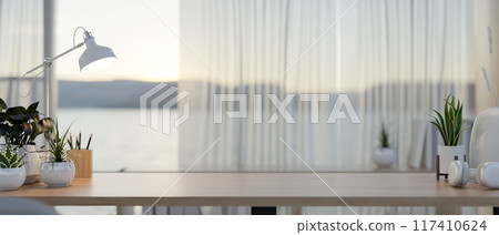 A copy space for displaying products on a wooden table by the window in a contemporary room. 117410624