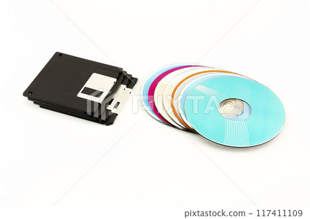 1.44 inch Floppy disks and CD / DVD discs lie on a white background 1.44 inch Floppy disks and CD / DVD discs lie on a white background 117411109
