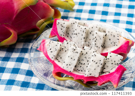 Dragon fruit cut into bite-sized pieces and served on a plate 117411393