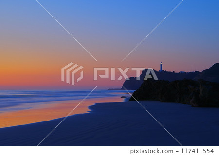 Scenery of the waves crashing on the sandy beach of Usuiso Beach and Shioyazaki Lighthouse against the backdrop of the dawn-colored sky Ver8 Scenery of the waves crashing on the sandy beach of Usuiso Beach and Shioyazaki Lighthouse against the backdrop of the dawn-colored sky Ver8 117411554