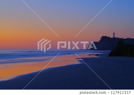 Scenery of the waves crashing on the sandy beach of Usuiso Beach and Shioyazaki Lighthouse against the backdrop of the dawn-colored sky Ver5 Scenery of the waves crashing on the sandy beach of Usuiso Beach and Shioyazaki Lighthouse against the backdrop of the dawn-colored sky Ver5 117411557