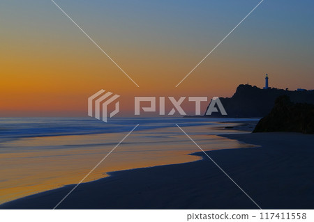 Scenery of the waves crashing on the sandy beach of Usuiso Beach and Shioyazaki Lighthouse against the backdrop of the dawn-colored sky Ver4 Scenery of the waves crashing on the sandy beach of Usuiso Beach and Shioyazaki Lighthouse against the backdrop of the dawn-colored sky Ver4 117411558