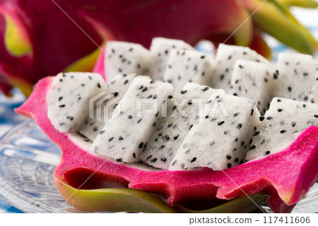 Dragon fruit cut into bite-sized pieces and served on a plate 117411606