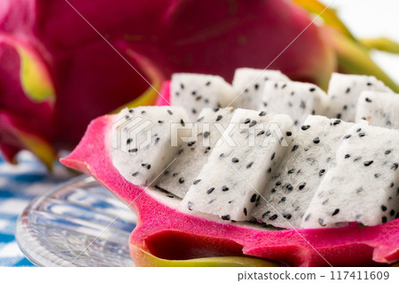 Dragon fruit cut into bite-sized pieces and served on a plate 117411609