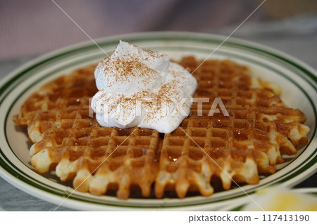Waffles with whipped cream on a plate Waffles with whipped cream on a plate 117413190