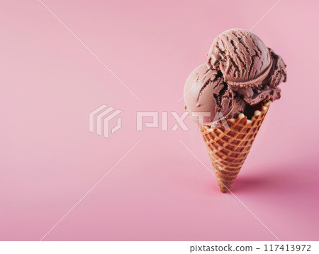 Chocolate ice cream in a waffle cone on pink background 117413972