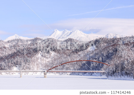 Yubari City, Hokkaido, Shiragane Bridge spanning the completely frozen Lake Shuparo and Mount Yubari and Mount Maedake [January] 117414246