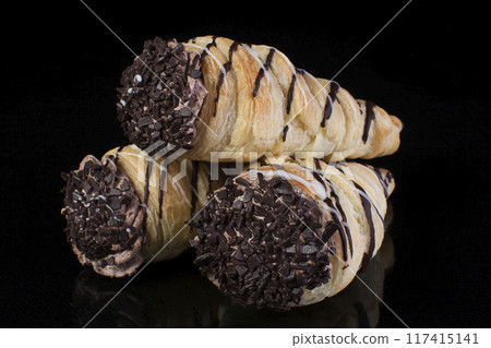 Puff pastry with cream coated chocolate on dark background 117415141