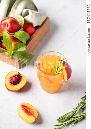 Refreshing peach tea with ice and rosemary. Homemade cold healthy vegetarian drink  117415882
