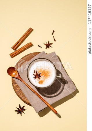 Traditional Indian masala chai latte in a glass cup. Hot drink with milk, spices and herbs Traditional Indian masala chai latte in a glass cup. Hot drink with milk, spices and herbs 117416137