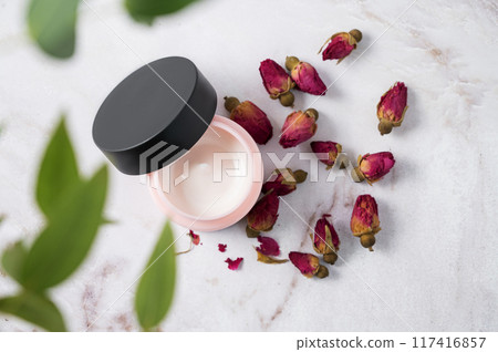 Face and body cream on a marble table with eucalyptus close up. The concept of care cosmetics 117416857