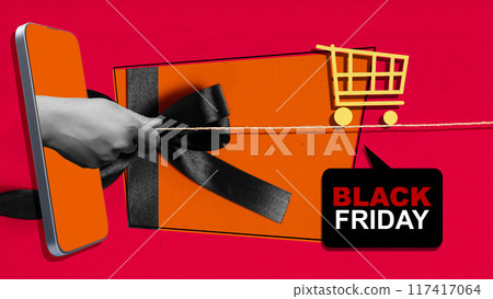 A phone is being used to cut a black ribbon, which is tied around a gift 117417064