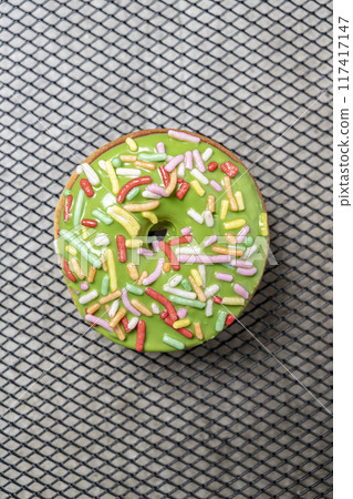 A green mini donut with sprinkles on top A green mini donut with sprinkles on top 117417147