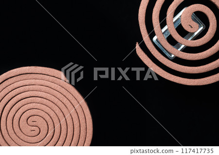 A mosquito coils is on a black background 117417735