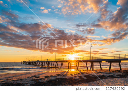 People walking on Glenelg Beach jetty during beautiful sunset 117420292