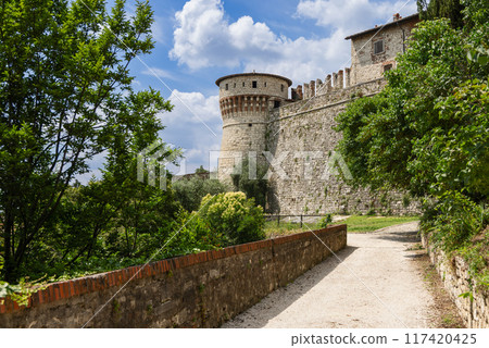 Pathway in Brescia castle park with Torre dei Prigionieri, greenery 117420425