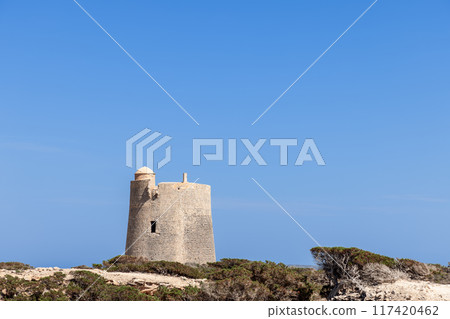 Simple and clean composition featuring Torre de ses Portes on Ibiza, set against a pristine blue sky 117420462
