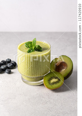 Green smoothie. Glasses of green avocado, kiwi detox smoothie. 117420910