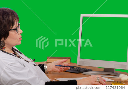 Experienced General Practitioner Provides Telehealth Consultation Using Chroma Key Monitor in Green Screen Environment. Experienced General Practitioner Provides Telehealth Consultation Using Chroma Key Monitor in Green Screen Environment. 117421064