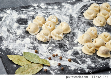Homemade meat dumplings ready for cooking, a classic dish perfect for hearty family meals 117421135