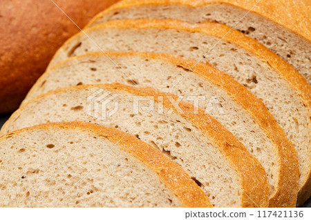 Sliced round loaf of freshly baked bread, perfect for breakfast or sandwich making Sliced round loaf of freshly baked bread, perfect for breakfast or sandwich making 117421136