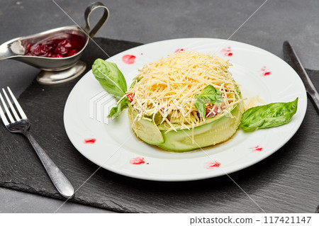 Fresh zucchini salad with parmesan cheese, basil leaves, and berry sauce on a gourmet plate 117421147