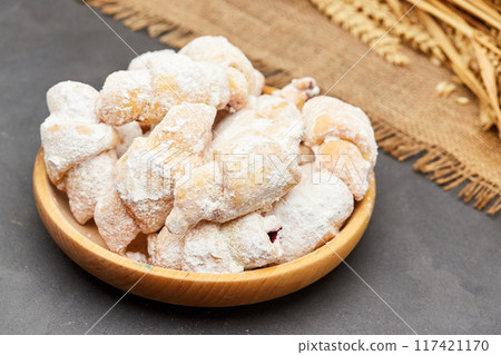 Powdered sugar-coated pastries filled with jam, perfect for sweet cravings and dessert lovers 117421170