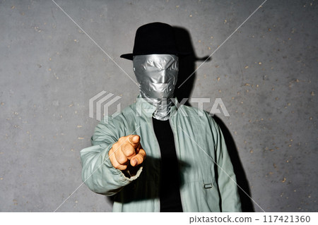 Mystery man with duct tape face pointing his finger to you and camera 117421360