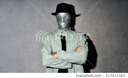 Mystery man with duct tape face wrap with crossed arms 117421363