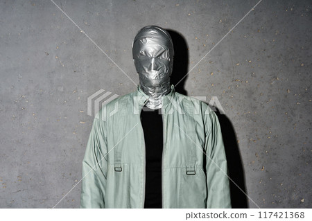 Mystery man with duct tape face wrap on gray background 117421368